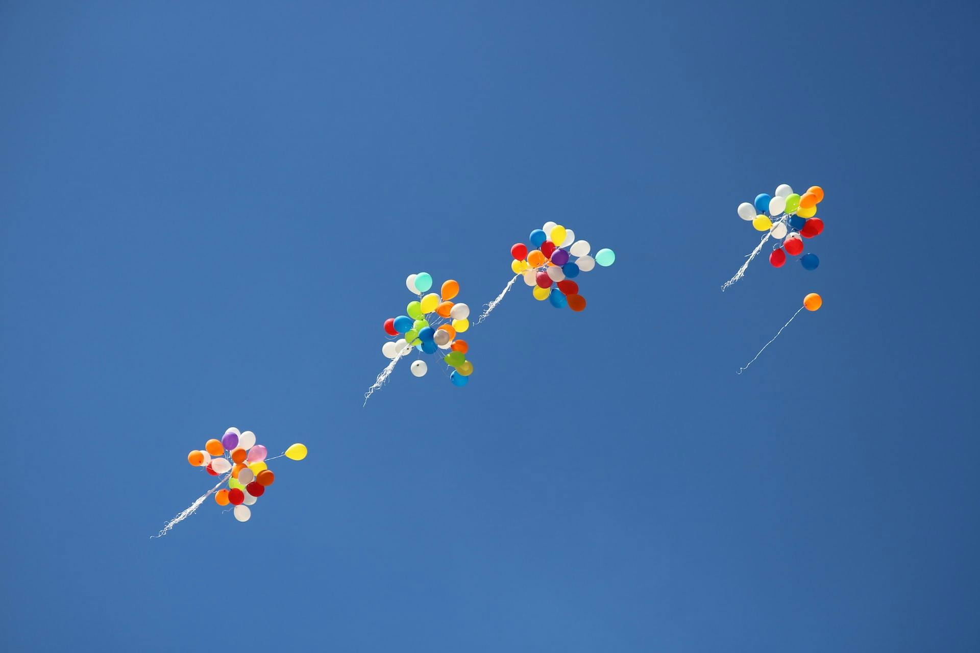 Image of balloons floating away in the air
